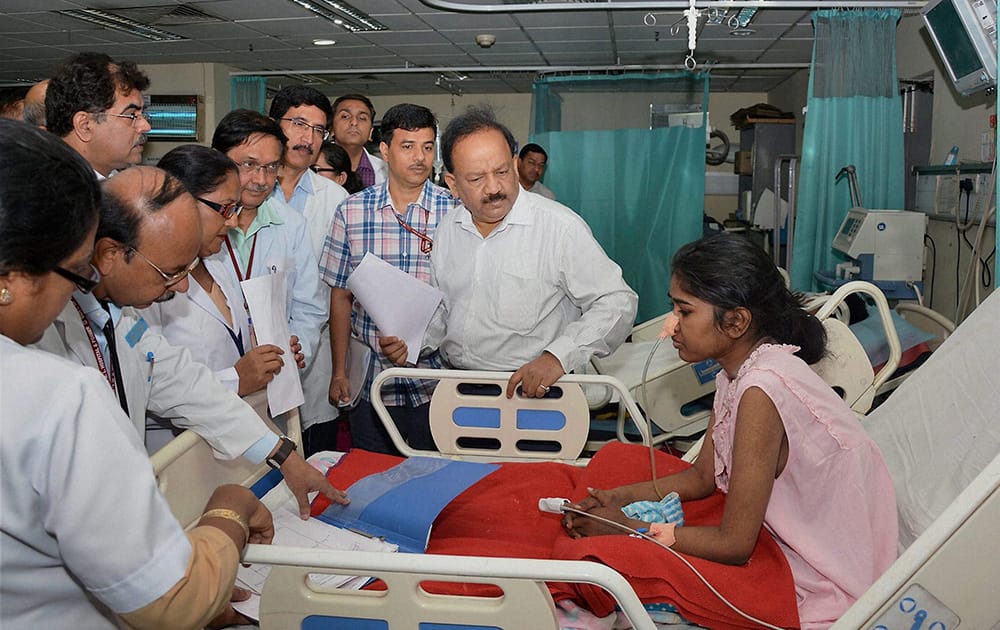 Union Minister for Health and Family Welfare, Harsh Vardhan interacts with a patient during a visit to Dr. Ram Manohar Lohia Hospita in New Delhi.