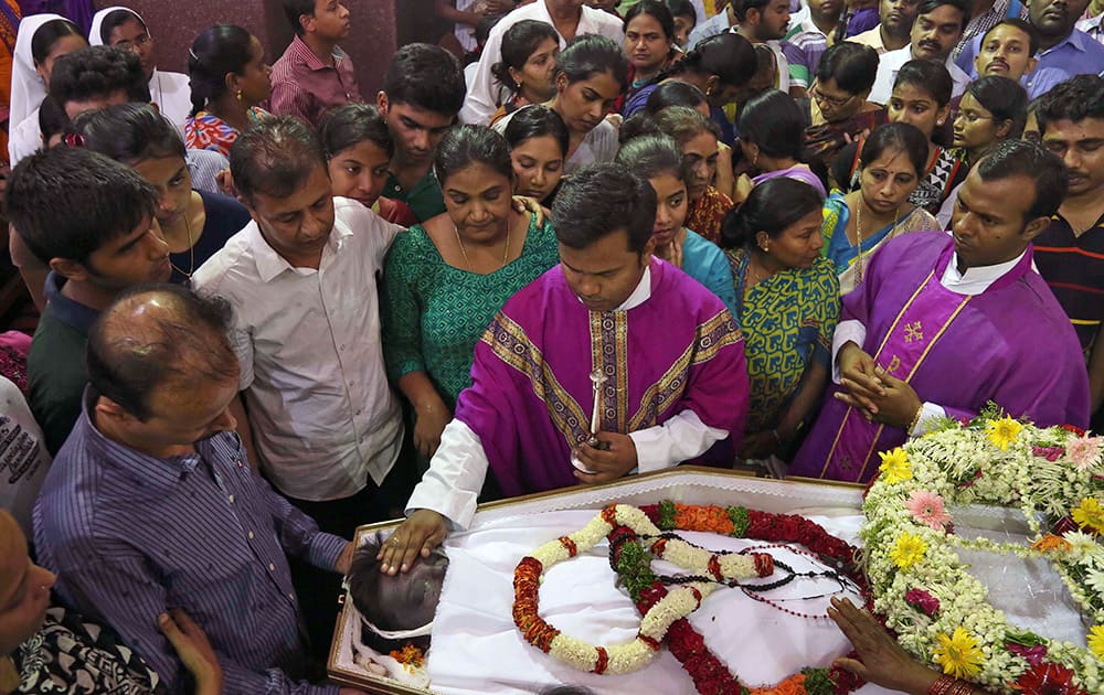 Catholic priests offer prayers during the funeral mass of Devasish Bose at St. Joseph Cathedral in Hyderabad.