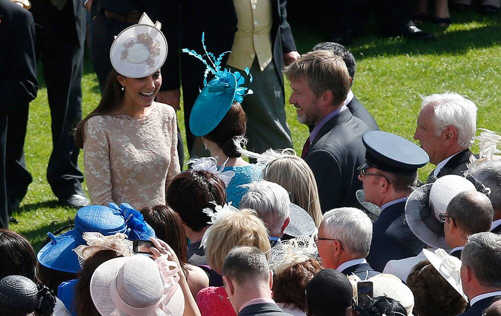 Briatin`s Kate, Duchess of Cambridge, left, meets guests at the garden party at Buckingham Palace in London.