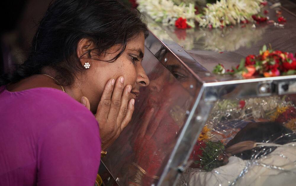 The mother of Gampala Aishwarya, one of the students who was swept away in a sudden dam release, weeps at their residence during her funeral in Hyderabad.