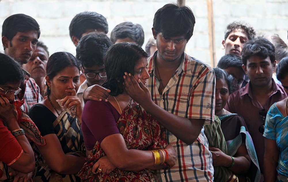 The mother of Gampala Aishwarya, one of the students who was swept away in a sudden dam release, and her brother cry during her funeral at her residence in Hyderabad.