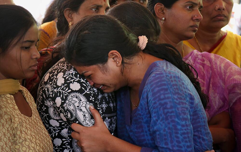 Relatives and friends mourn as they attend the last rites of Gampala Aishwarya, one of the students who was swept away in a sudden dam release, at her residence in Hyderabad.