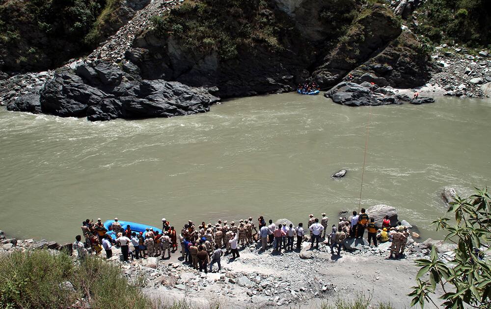 Rescuers continue to search the Beas River for the second day after dozens of students were swept away when a dam released a rush of water without warning near the Larji hydropower station, south of the mountain resort town of Manali in Himachal Pradesh.