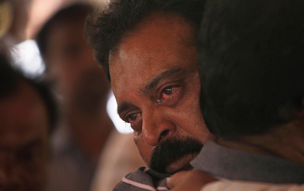 The father of Gampala Aishwarya, one of the students who was swept away in a sudden dam release, mourns during her funeral at their residence in Hyderabad.