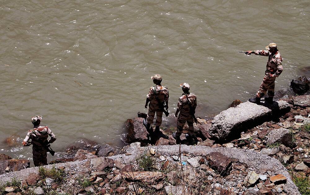 Rescuers search the Beas River after dozens of students were swept away when a dam released a rush of water without warning at Pandoh, about 90 kilometers (56 miles) south of the mountain resort town of Manali in Himachal Pradesh.