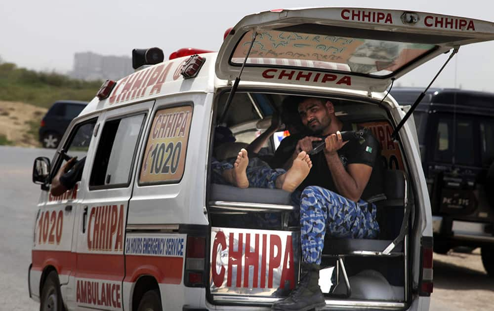 An ambulance rushes to a hospital after gunmen attacked a training center for airport security personnel in Karachi, Pakistan.