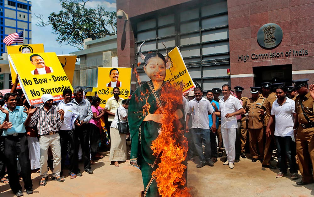 Sri Lankan pro-government supporters representing Federation of National Organizations burn an effigy of Tamil Nadu state Chief Minister Jayaram Jayalalitha during a demonstration outside the Indian High Commission in Colombo, Sri Lanka.