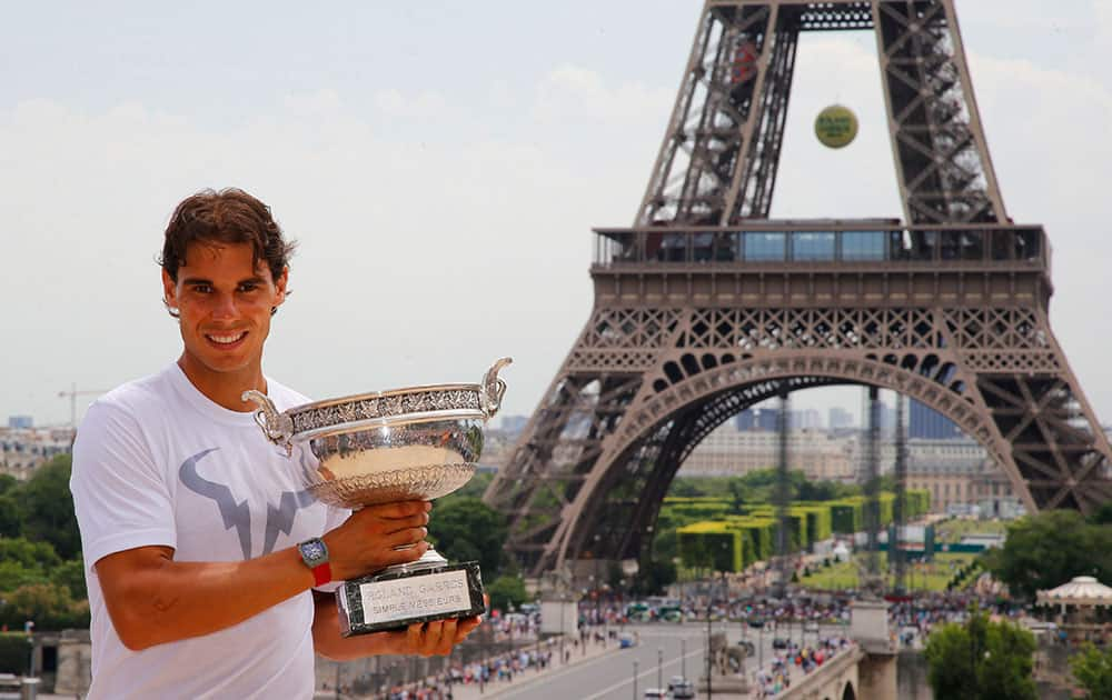 Spain`s Rafael Nadal poses with his French Open Tennis trophy during a photo session at Trocadero, next to the Eiffel Tower, in Paris.