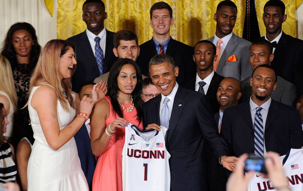 President Barack Obama shares a laugh with member of the NCAA Champion UConn Huskies Men’s and Women’s Basketball teams in the East Room of the White House in Washington.