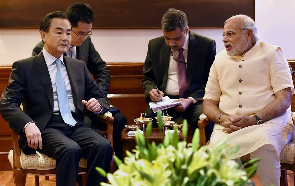 Visiting Chinese Foreign Minister Wang Yi, left, sits with Indian Prime Minister Narendra Modi, right during their meeting in New Delhi, India.