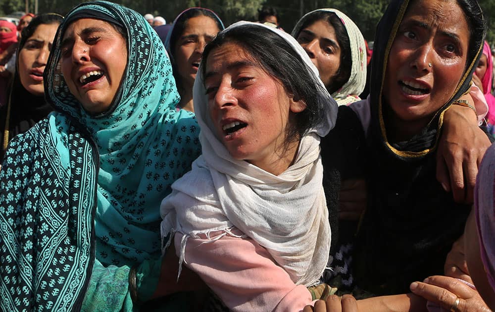 Women cry during the funeral procession of an alleged militant, Bilal Ahmed Bhat, at Lalhar Pulwama, south of Srinagar, India.