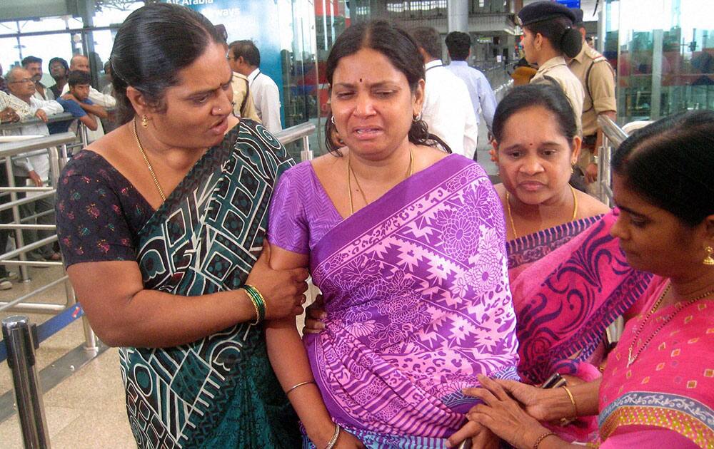 Relatives of engineering students who were swept away in River Beas in Mandi, Himachal Pradesh, weep as they leave from Shamshaabad airport for Mandi.