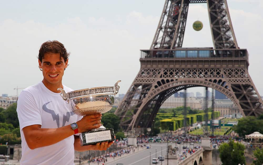 Spain`s Rafael Nadal poses with his French Open Tennis trophy during a photo session at Trocadero, next to the Eiffel Tower, in Paris. The 28-year-old Spaniard beat Novak Djokovic 3-6, 7-5, 6-2, 6-4 at Roland Garros to capture his fifth straight and career ninth French Open title.