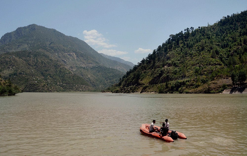 Rescuers search the Beas River after dozens of students were swept away when a dam released a rush of water without warning at Pandoh, about 90 kilometers (56 miles) south of the mountain resort town of Manali in Himachal Pradesh.