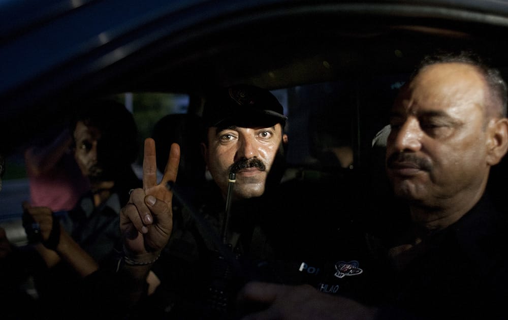 A Pakistani commando gestures while leaving the Jinnah International Airport in Karachi where security forces continue to battle militants in Pakistan.