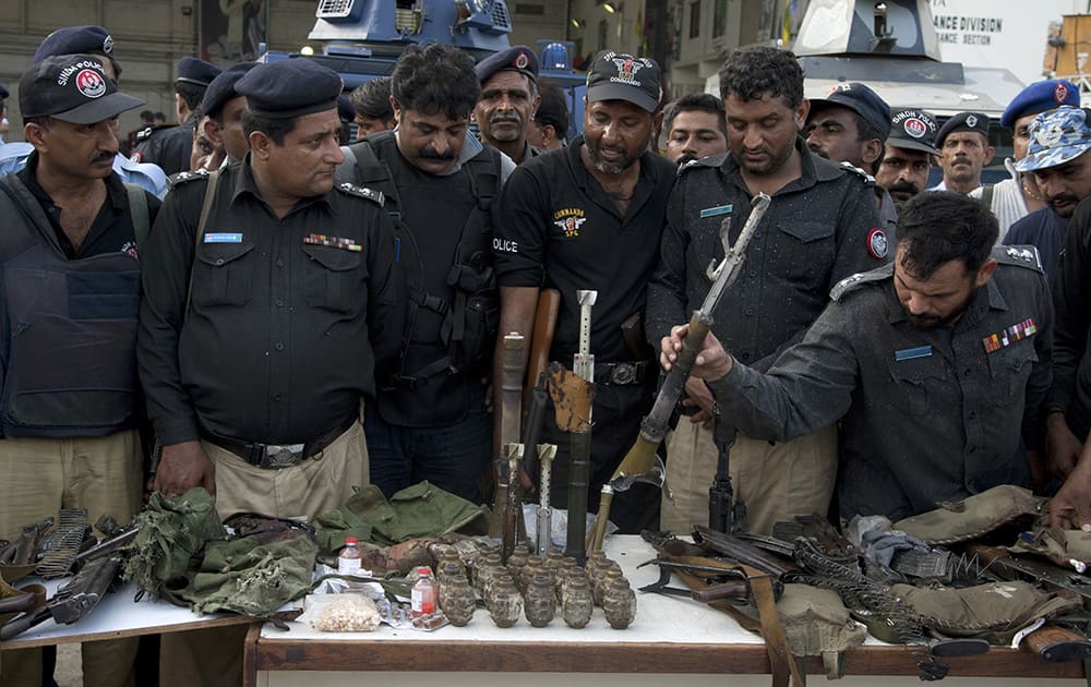 Pakistani police officers display ammunition confiscated from attackers at the Jinnah International Airport in Karachi, Pakistan. 