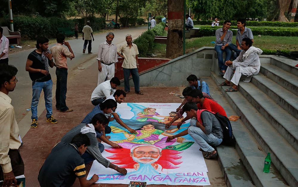 Students make a poster urging Prime Minister Narendra Modi to clean and save the River Ganges, holy to Hindus during the Ganga Dussehra festival in Allahabad.