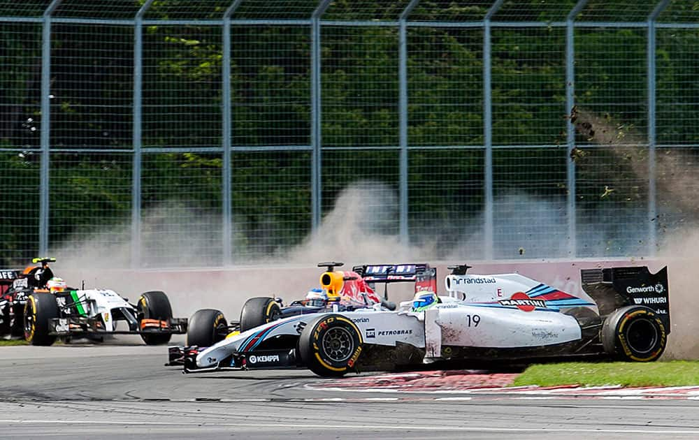 Williams driver Felipe Massa (19) from Brazil, crashes with Force India driver Sergio Perez, left, from Mexico, as Red Bull driver Sebastian Vettel, center, from Germany, drives through during the Canadian Grand Prix in Montreal. 