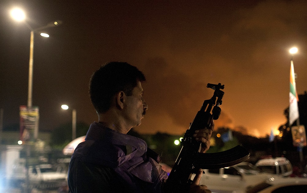 A Pakistani soldier takes position at Jinnah International Airport where security forces are fighting with gunmen who disguised themselves as police guards and stormed a terminal used for VIPs and cargo, Sunday night, June 8, 2014, in Pakistan.