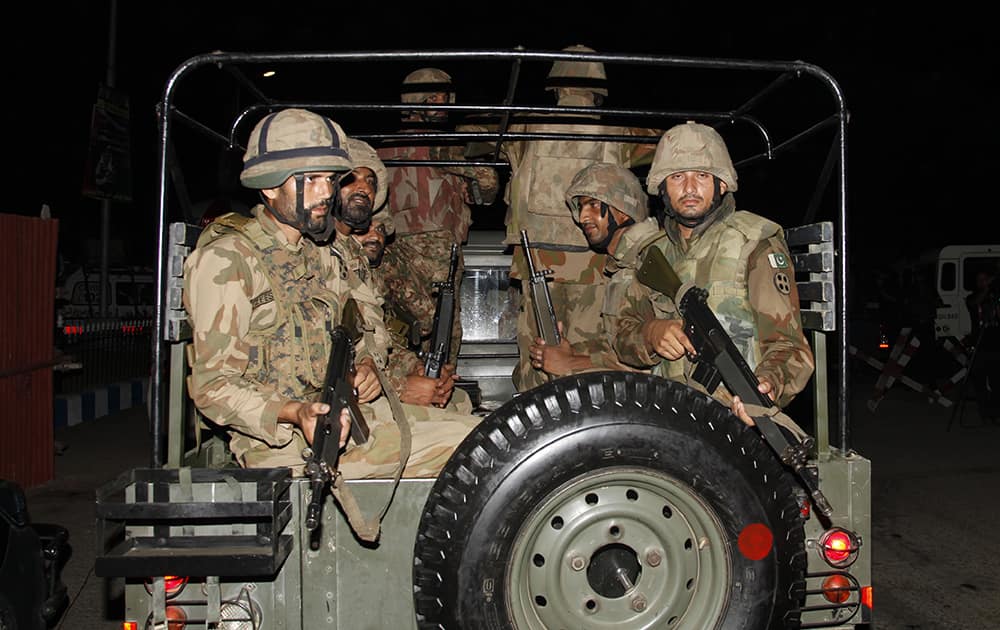 Pakistani troops arrive at Jinnah International Airport following an attack by unknown gunmen disguised as police guards who stormed a terminal used for VIPs and cargo, in Karachi, Pakistan. 