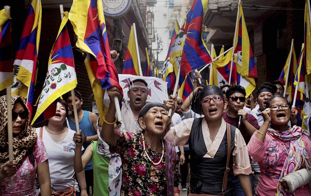 Exiled Tibetans shout slogans during a protest against the visit of Chinese Foreign Minister Wang Yi in New Delhi.