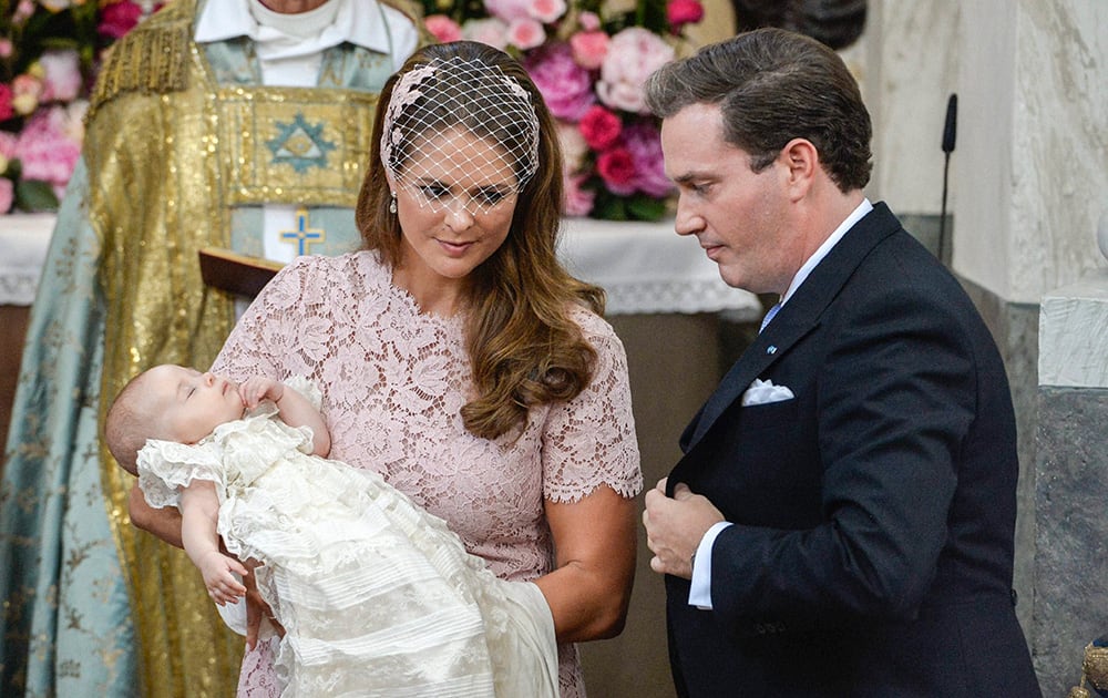 Princess Madeleine holds her daughter Princess Leonore watched by Christopher O`Neill, Princess Leonore`s father, during the christening ceremony in the Drottningholm Palace church outside Stockholm.