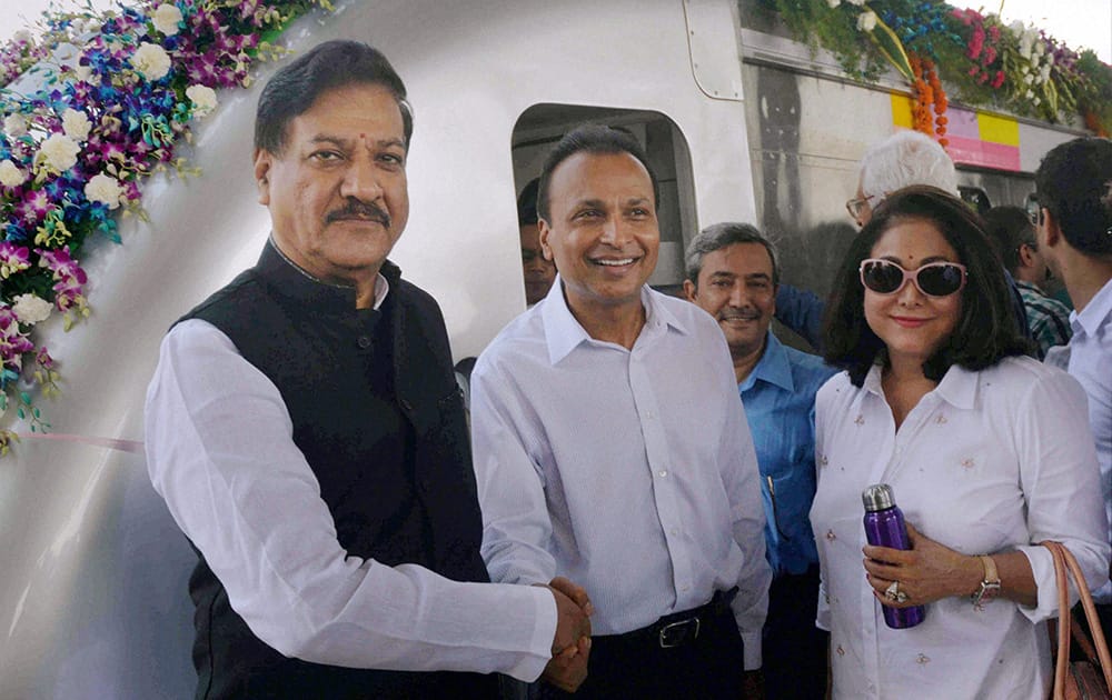 Maharashtra Chief Minister Prithviraj Chavan shakes hands with Anil Ambani as Teena Ambani looks on during the inauguration of Mumbai`s first Metro starting from Versova station towards Ghatkopar station.