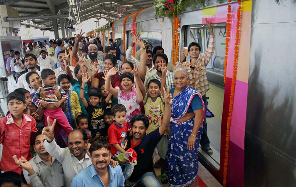 Excited commuters get ready to take a ride in Mumbai`s first Metro Rail from Versova Station to Ghatkoper Station in Mumbai.