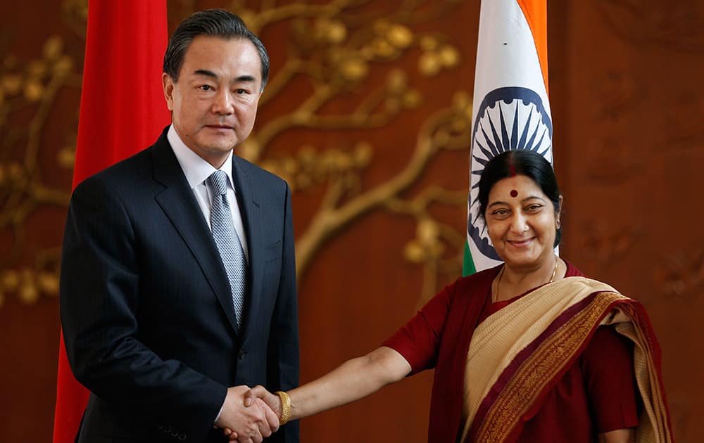 Indian External Affairs Minister Sushma Swaraj, shakes hands with her Chinese counterpart, Wang Yi, before their meeting in New Delhi.