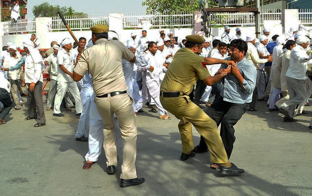 Policemen arresting Patwaris during their protest in Rohtak.