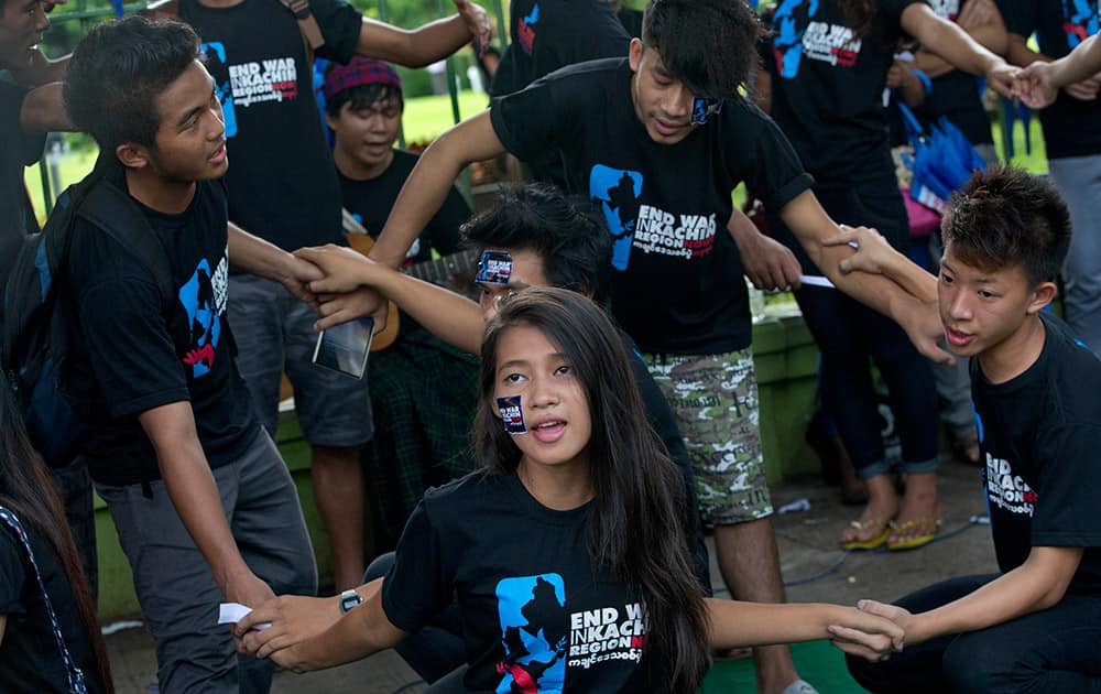 Young Kachin activists perform a street theater calling to end the fighting between the Myanmar military and ethnic armys in the northern Kachin region marking the third anniversary of the resumption of fighting between the Kachin rebels and the Myanmar army in Yangon, Myanmar.