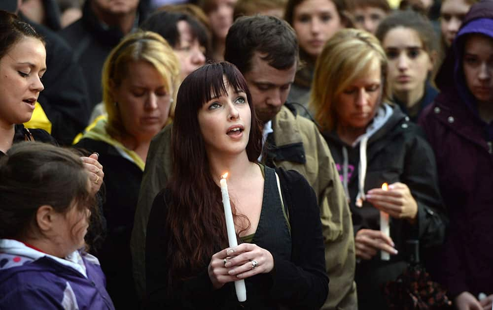 People take part in a candlelight vigil outside Royal Canadian Mounted Police headquarters in Moncton, New Brunswick, Canada.