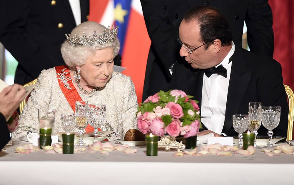 Britain`s Queen Elizabeth II listens to French President Francois Hollande during a state dinner at the Elysee presidential palace in Paris.