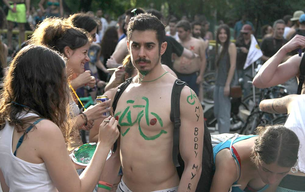 Protesters paint their bodies during a bicycle protest in the northern Greek city of Thessaloniki.