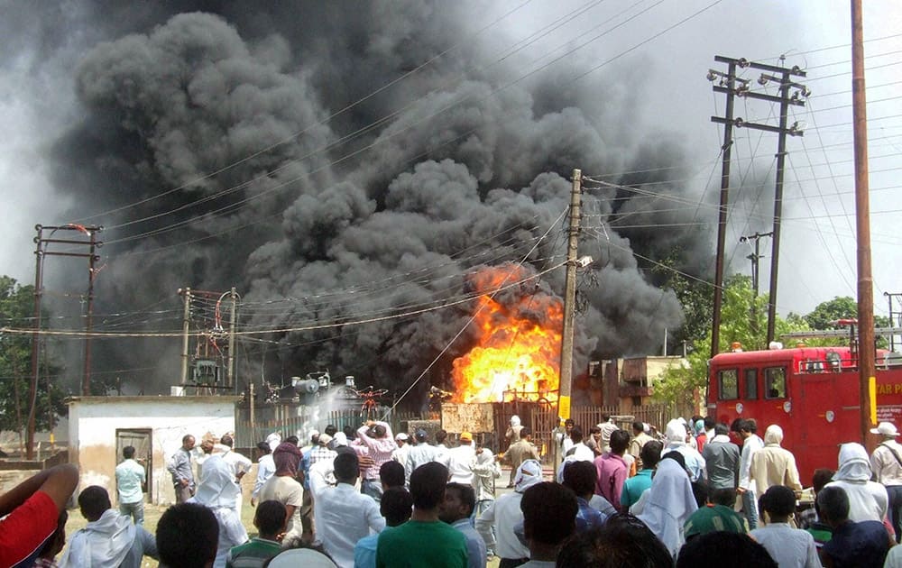 Flames and smoke coming out of Shakhowa power house plant after a fire, in Mirzapur.