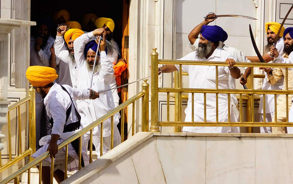 Members of a hardline Sikh group clash with guards of the Sikh’s holiest shrine, the Golden Temple, in Amritsar.