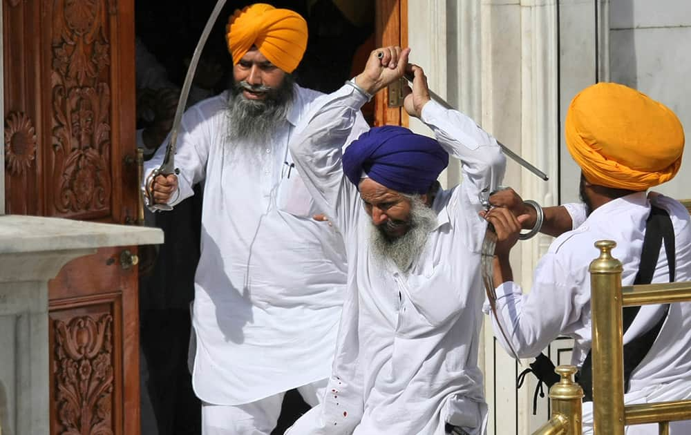 Members of a hardline Sikh group clash with guards of the Sikh’s holiest shrine, the Golden Temple, in Amritsar.