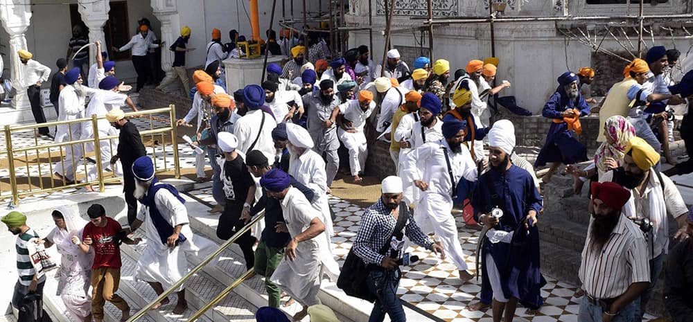 A scene of clash between SGPC supporters and a radical Sikh organisation on the 30th anniversary of Operation Bluestar, at Golden Temple Complex in Amritsar.