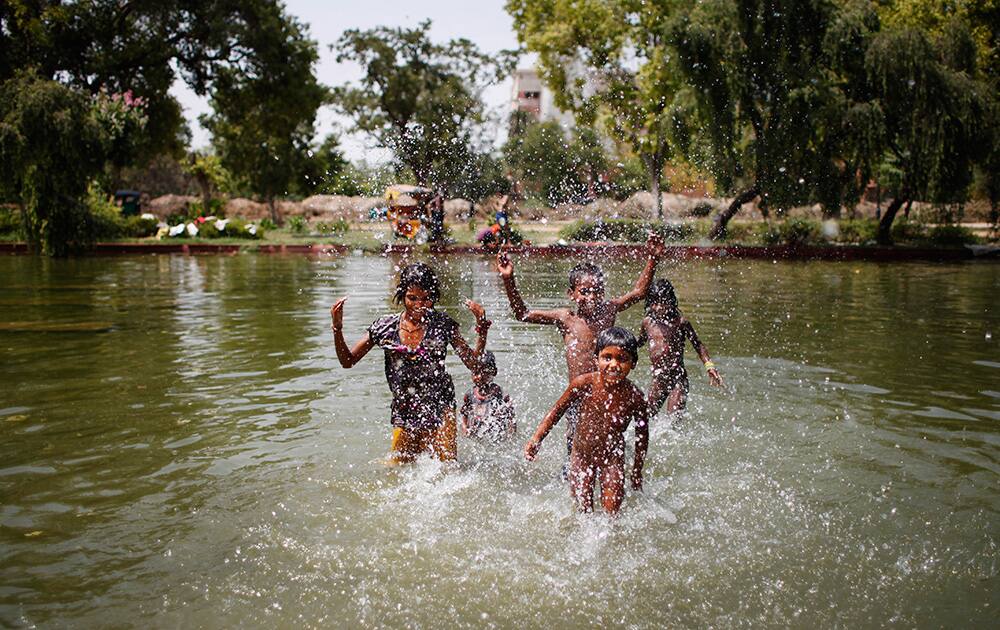 Children swim in a pond on a hot summer afternoon in New Delhi.