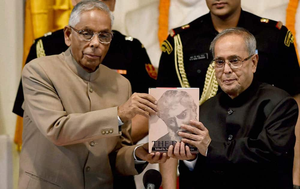 President Pranab Mukherjee receives the first copy of the second edition of The Dawn, Volume-I, from WB Governor M K Narayanan during inauguration of a programme to celebrate 150th Birthday of Acharya Satis Chandra Mukherjee in Kolkata.