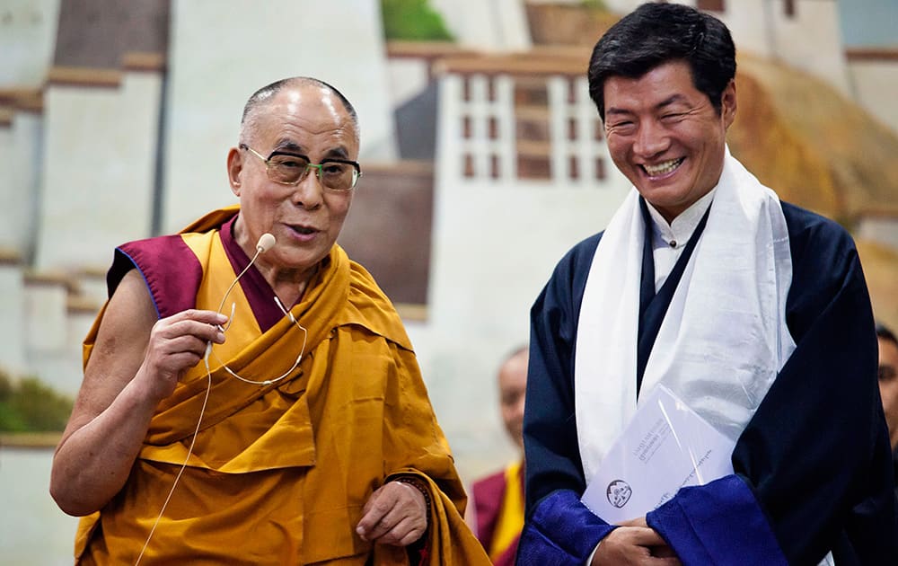 Lobsang Sangay, prime minister of the Tibetan government-in-exile, right, smiles as he listens to spiritual leader the Dalai Lama at the Tibetan Children’s Village School in Dharmsala.