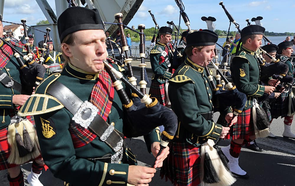 A Scottish pipe band parades on Pegasus Bridge in Benouville western France.