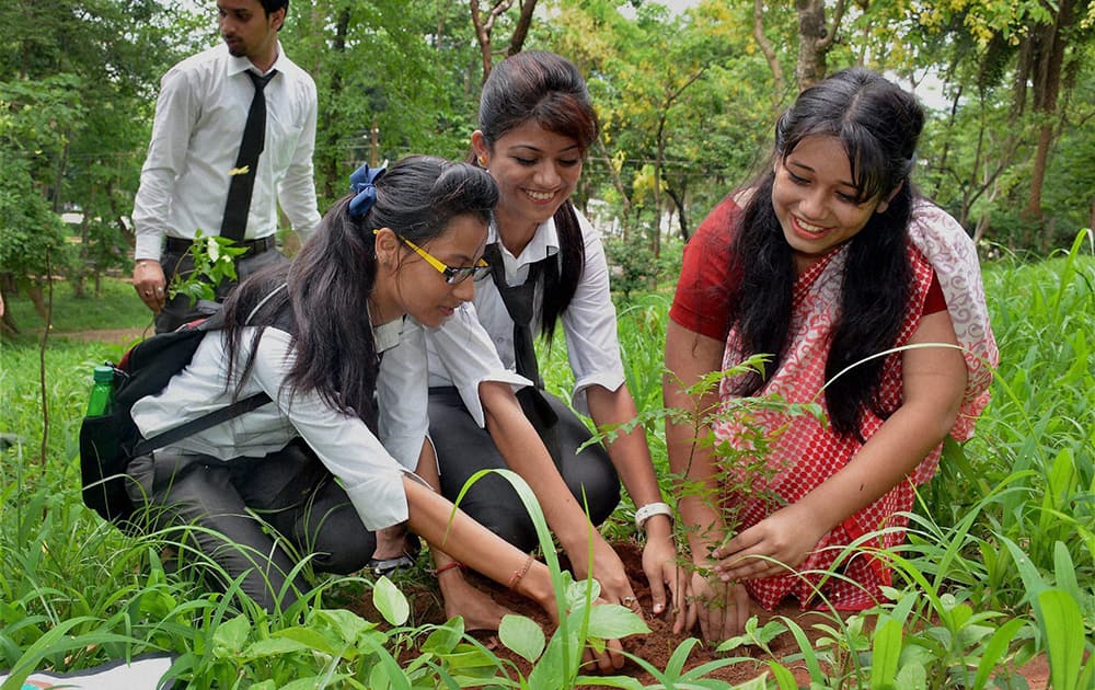 Students of Asian Institute of Management and Technology (AIMT) planting tree saplings at Assam State Zoo on the occasion of World Environment Day in Guwahati.