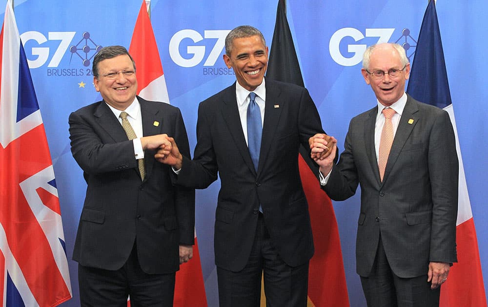 European Commission President Jose Manuel Barroso, left, and European Council President Herman Van Rompuy, right, welcome U.S. President Barack Obama at the G7 meeting at the European Council building in Brussels.