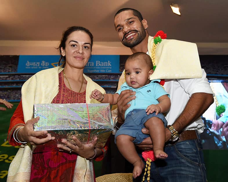 Cricketer & Brand Ambassador of Canara Bank Shikhar Dhawan with Wife Ayesha and son Joravar during his visit to bank in Bengaluru.