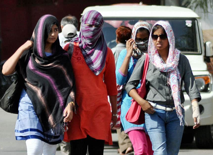 Girls cover their faces with scarves to protect themselves from scorching heat in Lucknow.