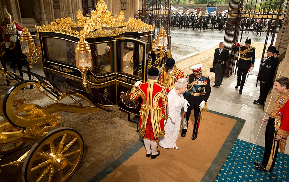 Britain`s Queen Elizabeth II arrives in the new Diamond Jubilee State coach, to deliver her speech, at the Palace of Westminster , in London. The State Opening of Parliament is an annual pageant of pomp and politics centered on the Queen`s Speech, a legislative program written by the government but read out by the monarch before a crowd of lawmakers. 