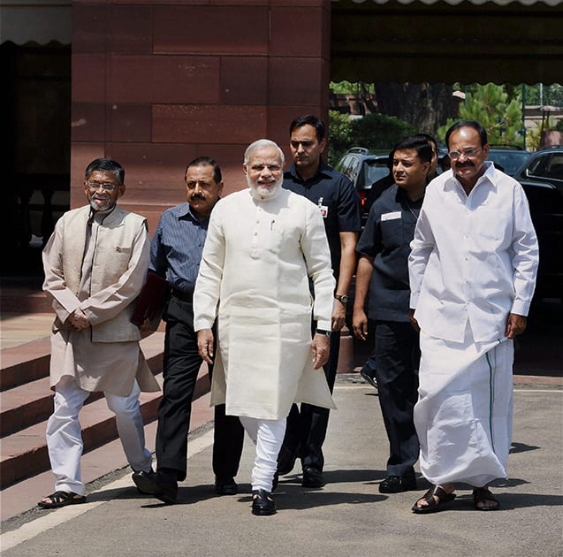 Prime Minister Narendra Modi being welcomed by Union Minister for Parliamentary Affairs M Venkaiah Naidu and MoS Santosh Kumar Gangwar at Parliament House on the first day of 16th Lok Sabha, in New Delhi.