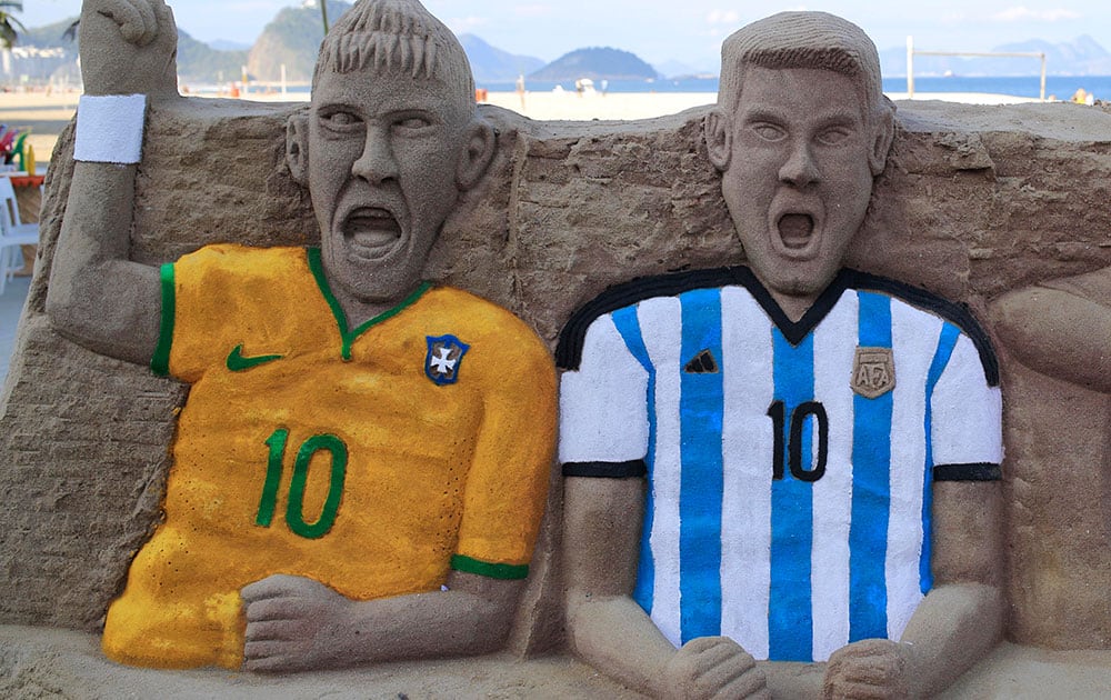 A sand sculpture featuring soccer players, Neymar of Brazil, left, and Lionel Messi of Argentina, on Copacabana beach in Rio de Janeiro, Brazil.