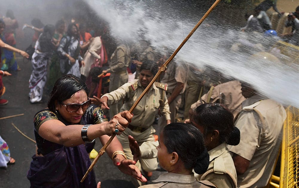 A woman, one among the protestors demonstrating outside the office of Uttar Pradesh state chief minister Akhilesh Yadav, demanding that he crack down on an increasing number of rape and other attacks on women and girls, scuffles with police in Lucknow.